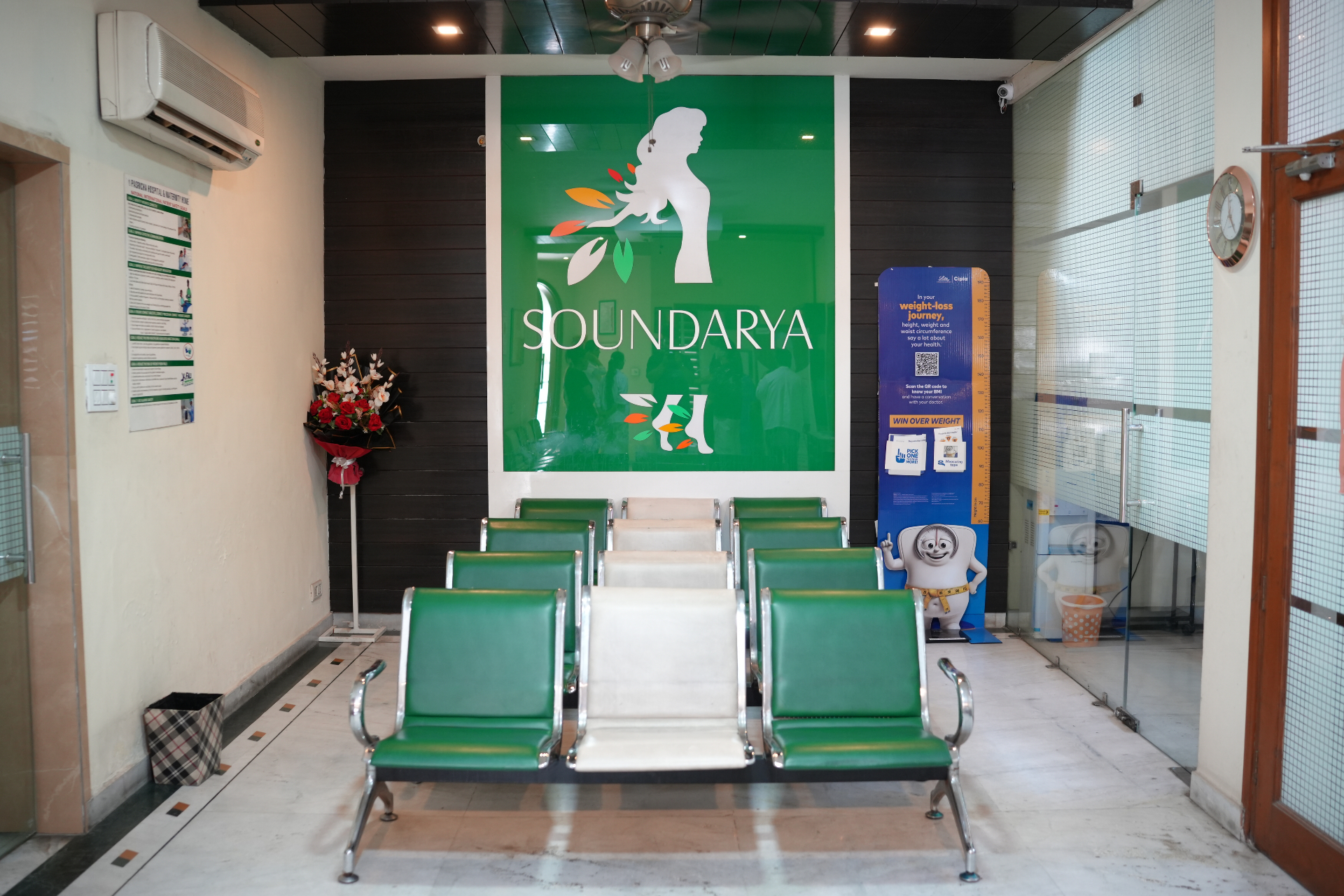 Soundarya Hospital reception lobby with signature green seating